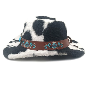 Detail view of cow print cowboy hat with embroidered ethnic band and turquoise stone