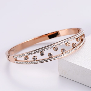 Detailed view of rose gold titanium steel bracelet with pavé white zircon stones