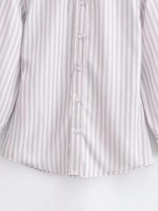 Detail of grey and white striped shirt showing the fabric texture and white buttons