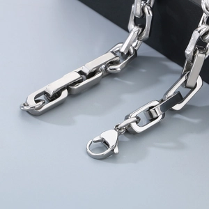 Macro detail of silver stainless steel rectangular chain links and lobster clasp