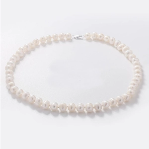 Detailed view of white freshwater pearl necklace with silver lobster clasp on white background