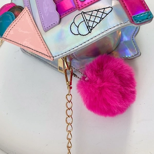 Detail of laser silver PU leather crossbody bag with pink faux fur pompom and chain