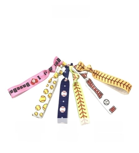 Detail of colorful softball hair ties with realistic ball patterns and baseball text