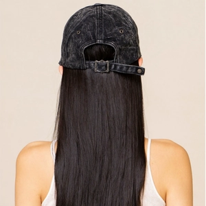 Detail of adjustable vintage metal buckle on a distressed black denim baseball cap