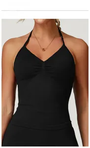 Detailed view of the pleated chest and halter neck design on a black sports tank top