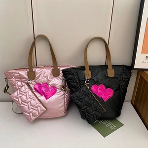 Detailed set of pink and black quilted tote bags with signature double heart decorations