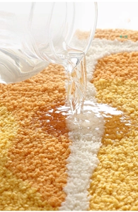 Macro shot of high-density flocked bath mat showing rapid water absorption on wavy pattern