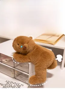 Detail of cute brown capybara plush toy showing fluffy texture and funny lying pose