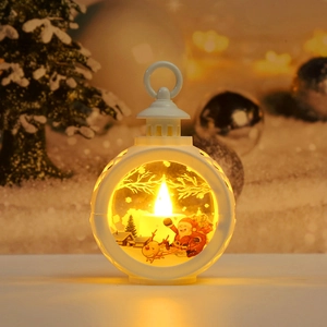 Detail of white Christmas LED lantern showing Santa Claus illustration and warm candle light