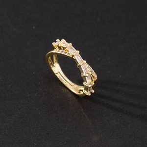 Macro detail of gold-plated layered ring with sparkling zircon and pavé diamonds