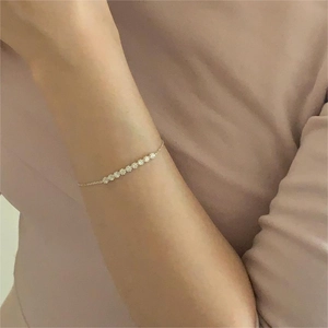 Close-up of S925 silver flower bracelet with sparkling white crystals in gold finish
