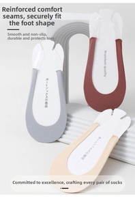Detail view of light grey, red and beige low cut invisible boat socks on white steps