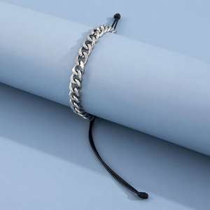 Men's hip-hop stainless steel curb chain and black braided rope bracelet on blue stand