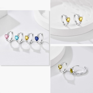 Detail of heart-shaped gemstone earrings with Celtic knot pattern and Huggie closure