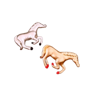 Set of two metal horse brooches in silver and champagne gold with dynamic running pose