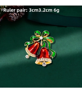 Detailed view of 3cm x 3.2cm Christmas twin bells brooch with red and green enamel coating