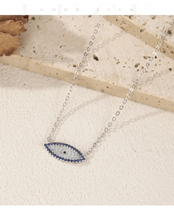 Macro shot of S925 silver Evil Eye pendant with blue cat eye stones and sparkling zircons