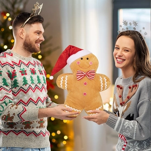 Close-up of plush gingerbread man toy held by model in festive Christmas scene