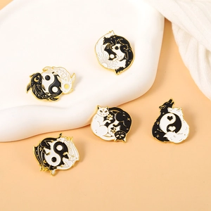 Collection of black and white Tai Chi enamel pins featuring cats and koi fish designs