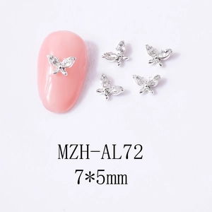 Macro view of 7x5mm silver butterfly nail charms with marquise cubic zirconia details