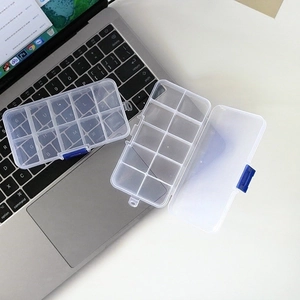Clear 10-compartment plastic jewelry storage box with blue buckles shown on laptop