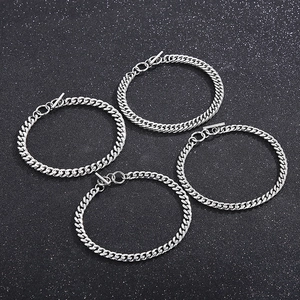 Set of four silver stainless steel Cuban link necklaces with OT toggle clasps on black background
