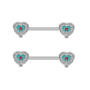 Close-up of heart-shaped nipple rings with blue enamel and pink rhinestones