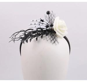 Gothic Halloween headband detail featuring white skull hand, rose and black mesh veil