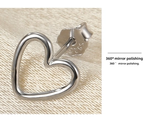 Macro shot of S925 sterling silver heart stud earrings with mirror polished finish