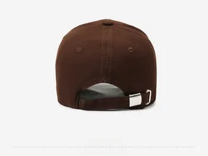 Detail view of the brown baseball cap featuring an adjustable silver metal slider buckle