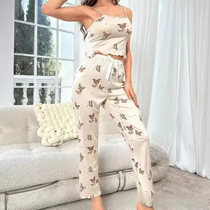 Detail of floral butterfly print on satin camisole top and long pajama trousers set