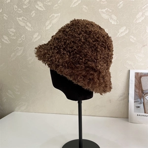 Close-up of brown teddy fur winter bucket hat with thick plush texture and warm material