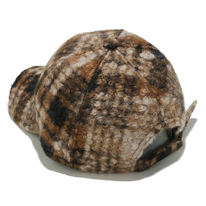 Detail of checkered sherpa baseball cap showing fuzzy texture and adjustable back strap