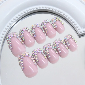 Sparkly French press-on nails with pink base and silver glitter rhinestone accents