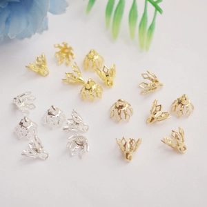 Macro detail of 14K gold-plated and silver hollow flower bead caps for DIY jewelry