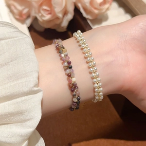 Detail of double-layer beaded bracelet featuring white pearls and colorful agate stones