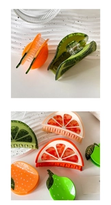 Detailed macro view of large acetate fruit hair claws in orange and lime designs