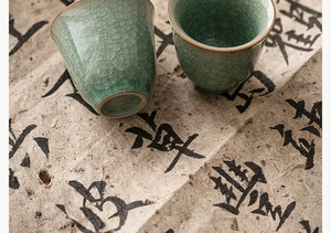 Detail view of celadon Ru kiln tea cups featuring distinct ice crackle glaze patterns