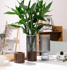 Detailed view of bark texture and vertical stripe glass vases with wooden bases for home decor