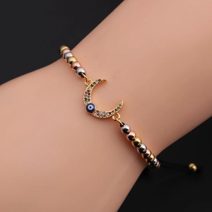 Bohemian 18k gold plated moon and evil eye adjustable bracelet on model wrist