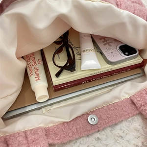 Interior view of pink fuzzy tote bag showing large capacity and magnetic metal closure