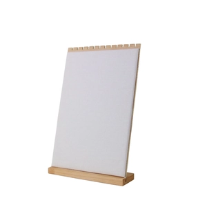 Vertical necklace display stand with wood base and white fabric panel for jewelry