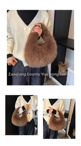 Detailed view of a brown faux fur crescent handbag with thick plush texture for winter