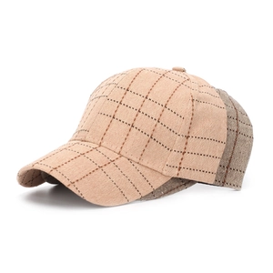 Detailed close-up of a vintage plaid baseball cap in beige with a structured crown
