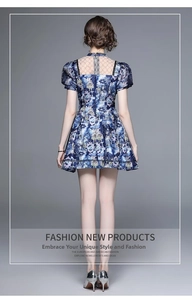 Detail of blue summer dress showing back cutout and black scalloped lace pattern
