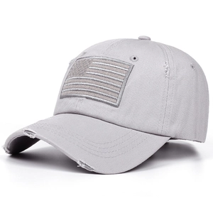 Detail of grey cotton baseball cap featuring distressed edges and American flag patch