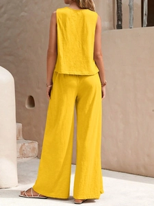 Detail of yellow two-piece summer set showing cotton linen texture and loose fit tailoring