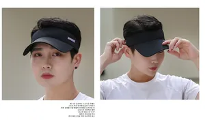 Detail of a black sun visor hat for sports with embroidery shown on a male model