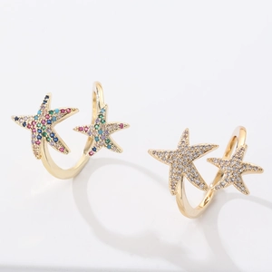 Macro view of adjustable starfish rings featuring colorful and clear cubic zirconia
