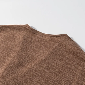 Detailaufnahme eines braunen Strickoberteils mit Rundhalsausschnitt und feiner Rippstruktur